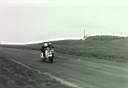 Geoff Stevens challenging unknown rider at Cadwell Park